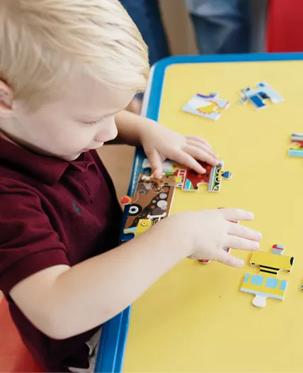 Child playing with puzzle at Childcare Center